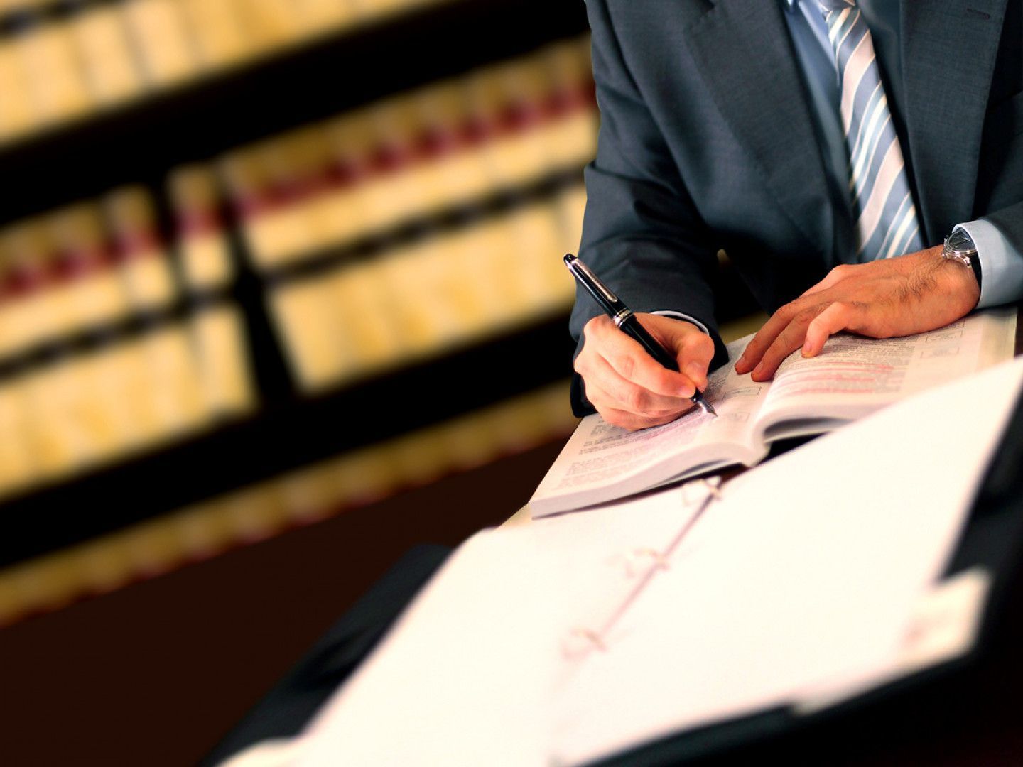 A statue of justice holding a scale in front of a book