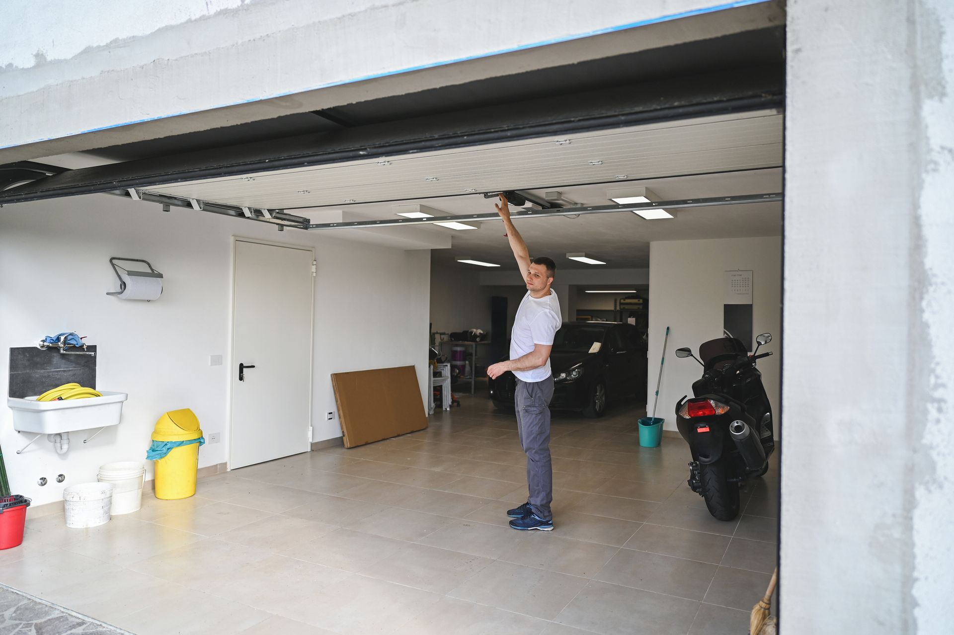 Man Holding Garage Door — Frankfort, IL — U.S. Overhead Door Inc.