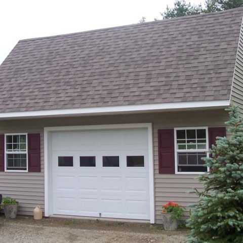 Single-car garage with white door, beige siding, maroon shutters, and a shingled roof.