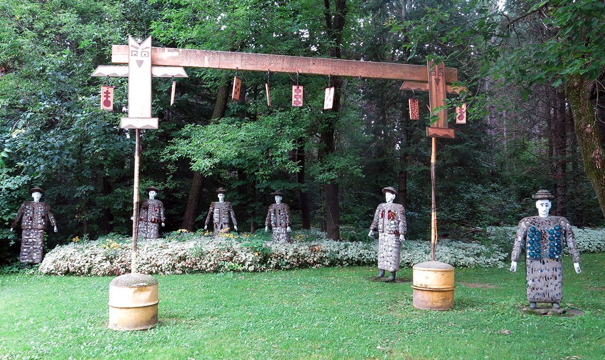 Outdoor archery range with targets set in front of a wooded backdrop and hanging target markers