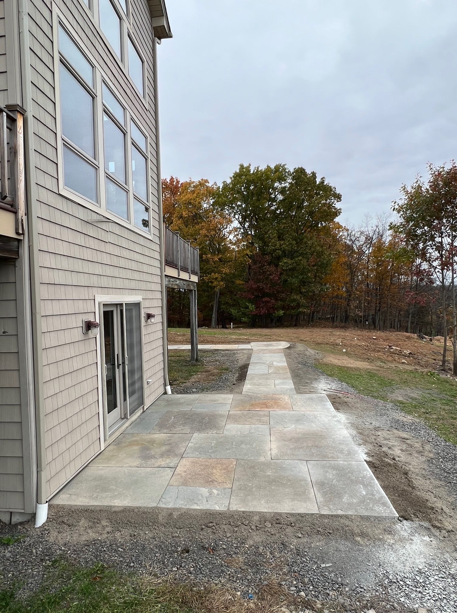 A house with a patio and a walkway leading to it.