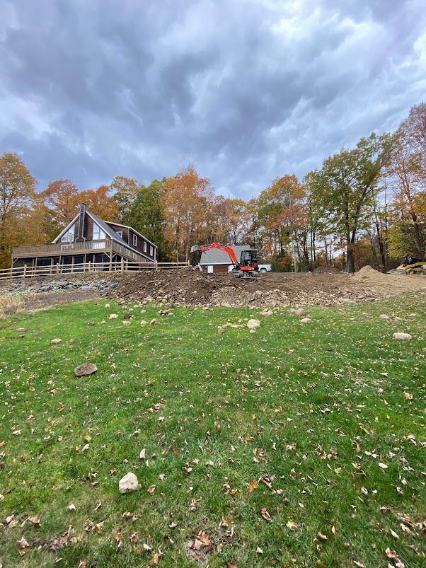 A house is being built in the middle of a grassy field.