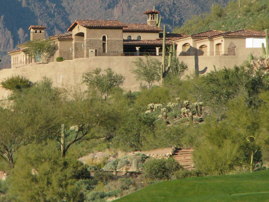 Arizona Home with beautiful natural landscaping. Traditional turf is installed at the bottom of the slope.