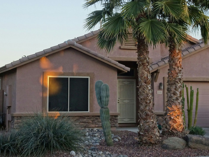Arizona home with clean, beautiful landscaping in the front yard.