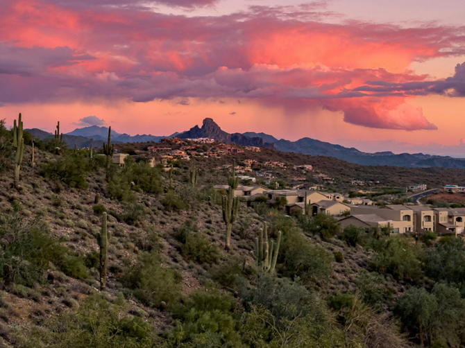 View of Fountain Hills, Arizona, at sunset showing the natural landscape and neighborhood nearby.