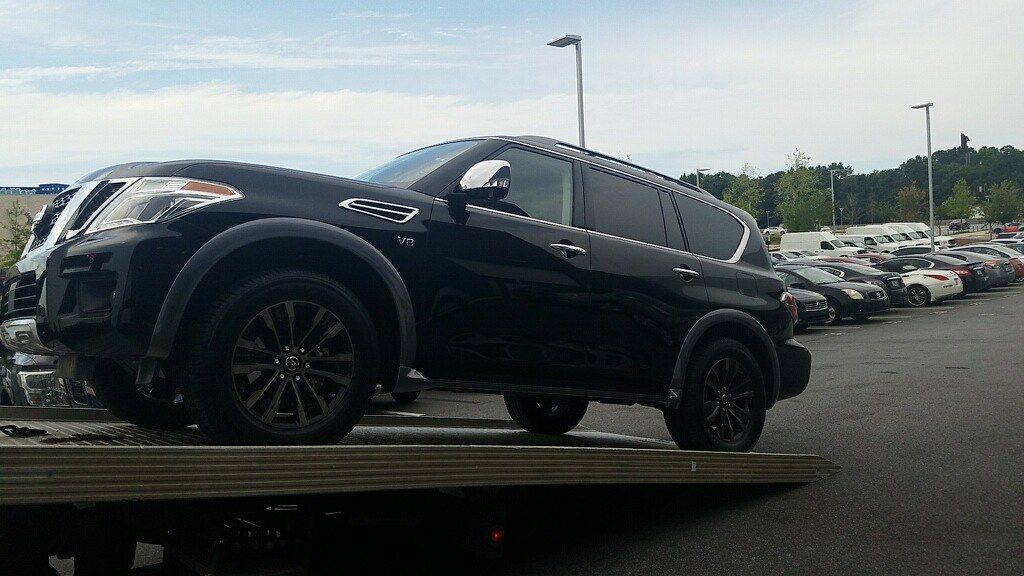Black Suv on a Tow Truck, Parked Outdoors — Best Price Towing in Newcastle, NSW