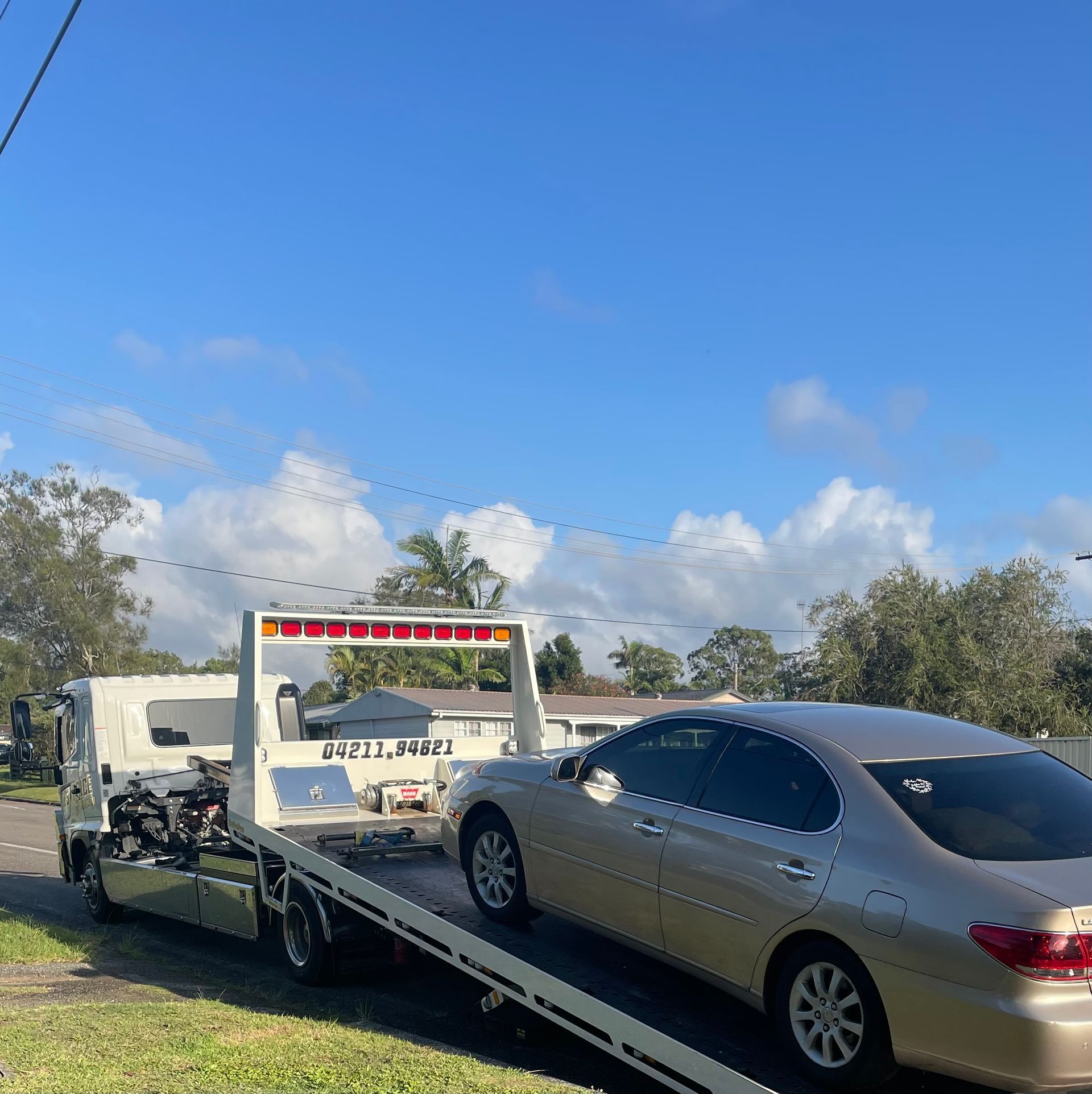 Car Being Towed by a Flatbed Tow Truck — Best Price Towing in Lake Haven, NSW