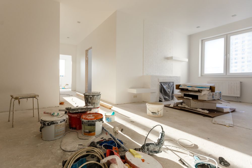 A Living Room Under Construction With A Lot Of Tools On The Floor — Auslinc Building Services In Forster, NSW