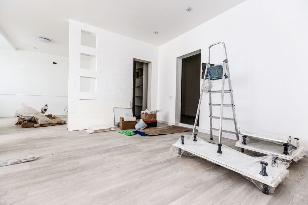 A Ladder Is Sitting On Top Of A Cart In An Empty Room — Auslinc Building Services In Forster, NSW