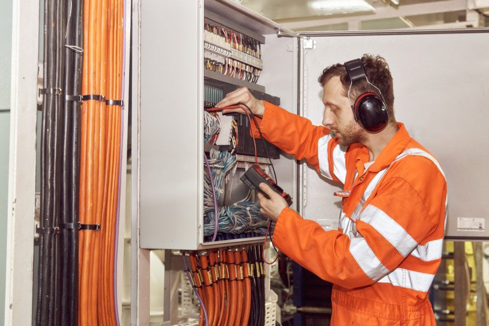 A Man Wearing Headphones Is Working On An Electrical Box
— L.A.F Electrical P/L In Terrigal, NSW