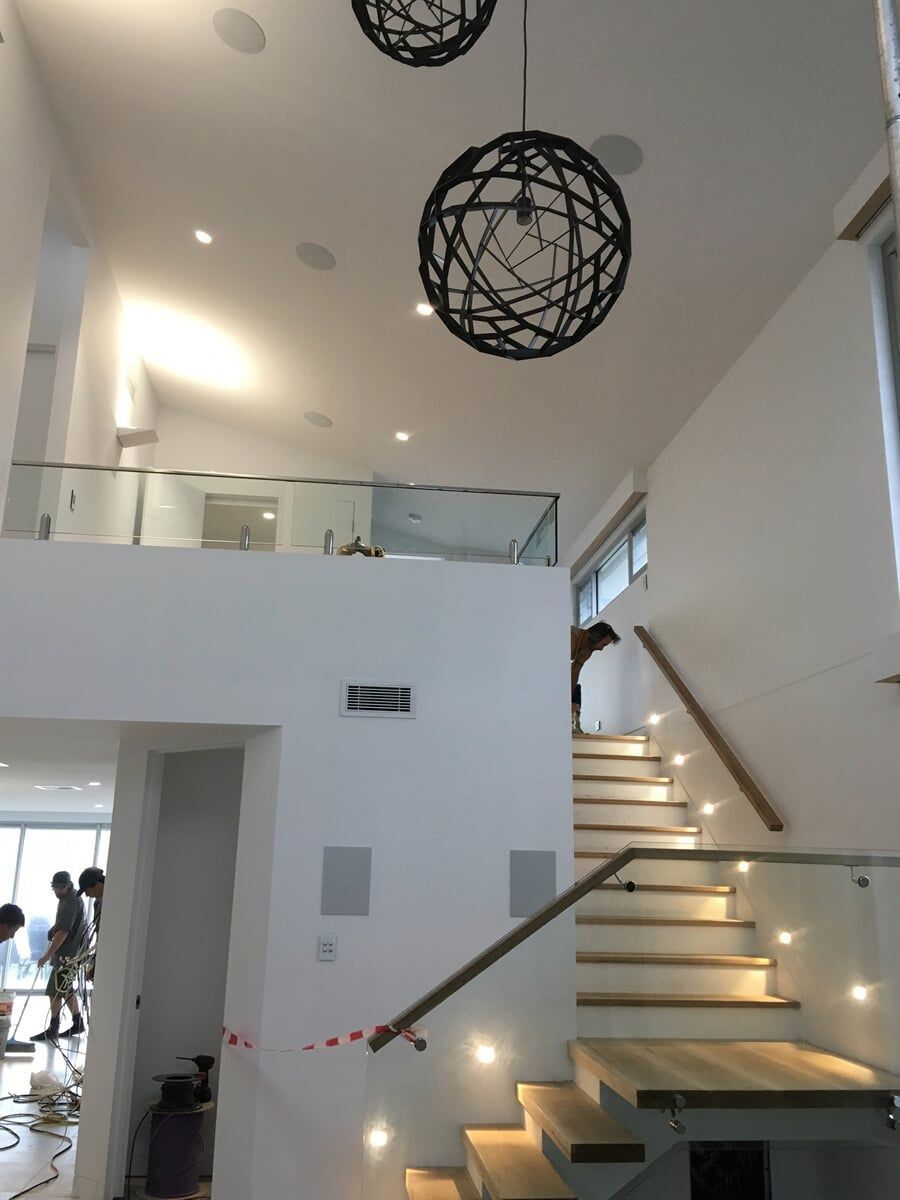 A Staircase With A Glass Railing And Lights On The Steps — L.A.F Electrical P/L In Empire Bay, NSW