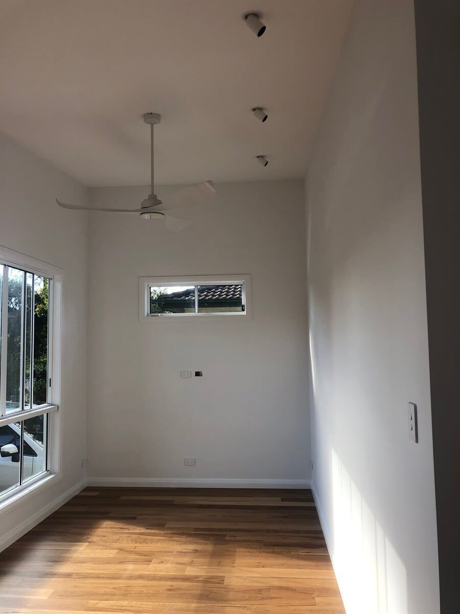 An Empty Room With A Ceiling Fan And A Window — L.A.F Electrical P/L In Empire Bay, NSW