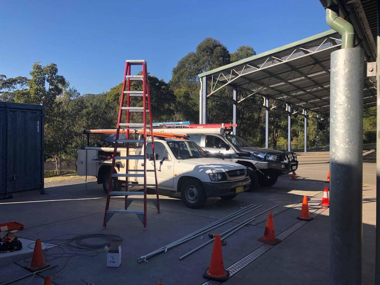 A Ladder Is Sitting Next To A Truck In A Parking Lot — L.A.F Electrical P/L In Empire Bay, NSW