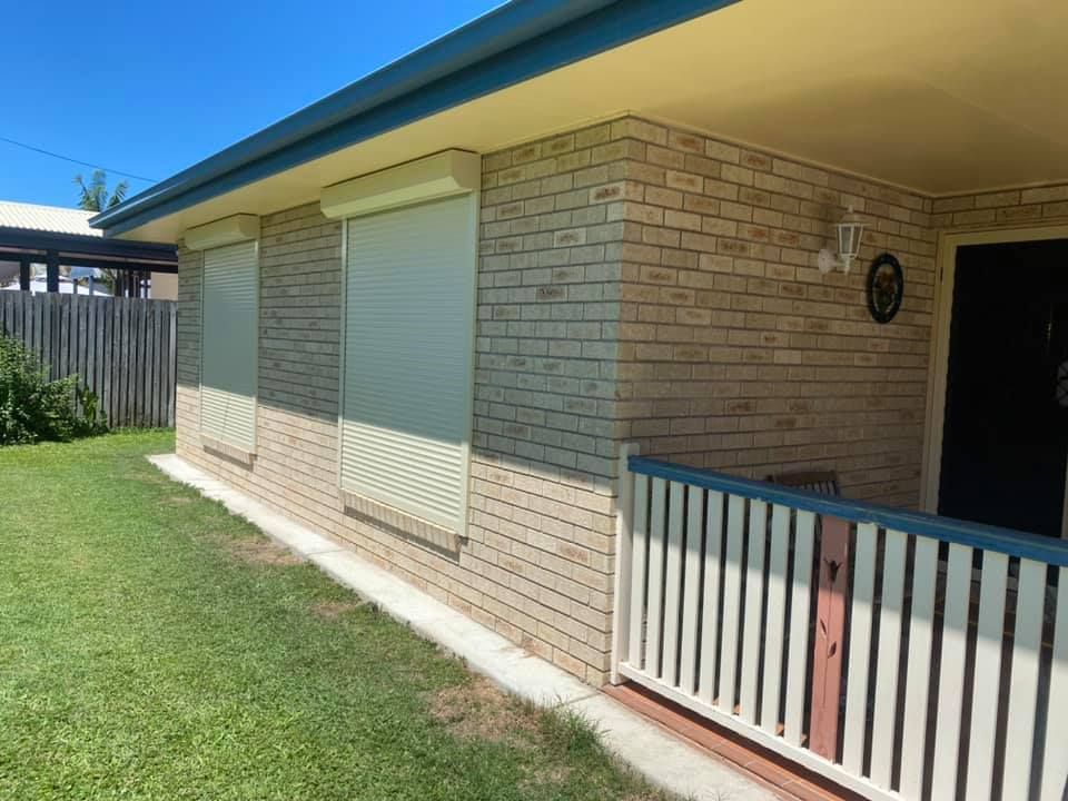 A Brick House With a Porch and Shutters on the Windows — Whitsunday Blinds & Security In Beaconsfield, QLD