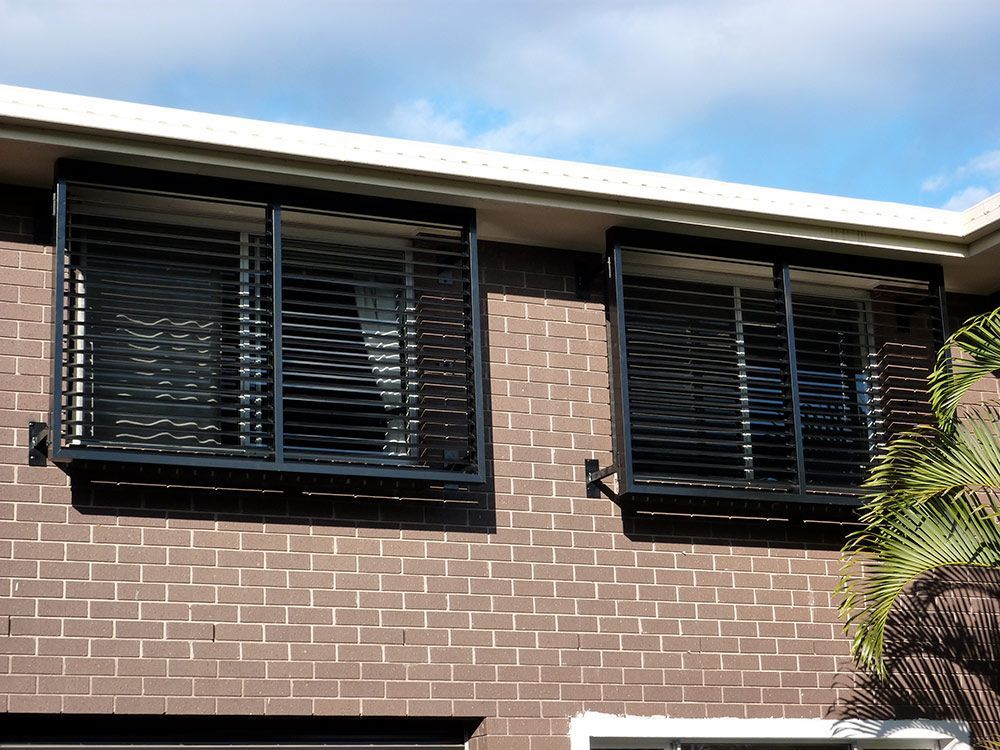 Two Windows With Black Blinds Shutter — Whitsunday Blinds & Security In Beaconsfield, QLD