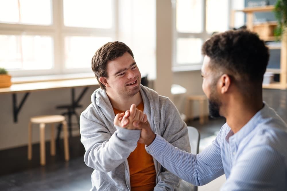 Young disabled man shaking hands with his mentor - First Aid in Mackay, QLD