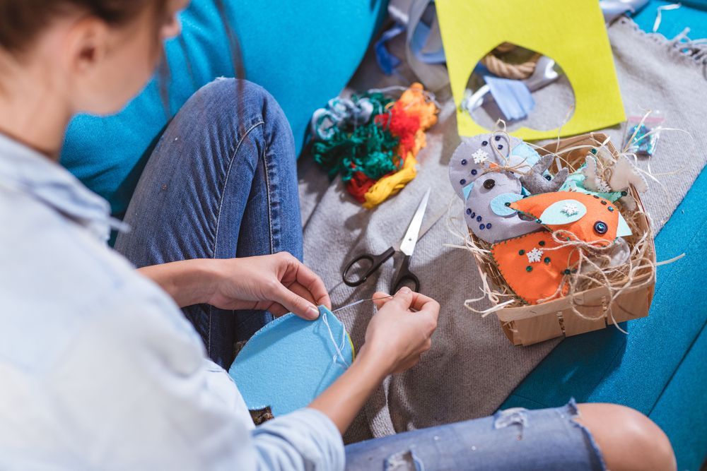 A young woman making arts & craft decorations using felt - First Aid in Mackay, QLD
