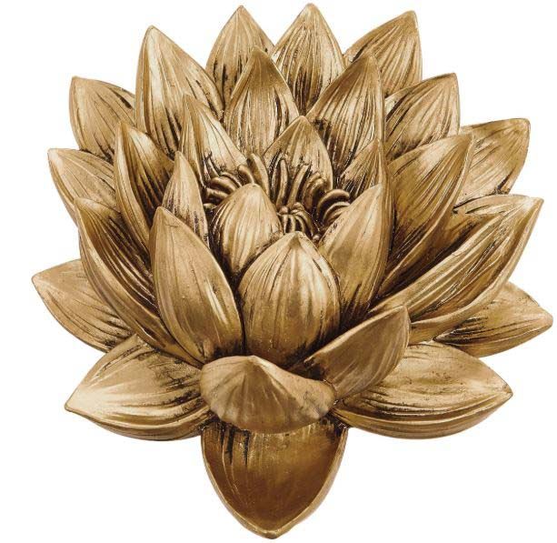 A close up of a gold flower on a white background