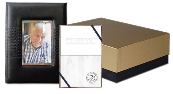 A picture of a man in a plaid shirt is in a picture frame next to a box.