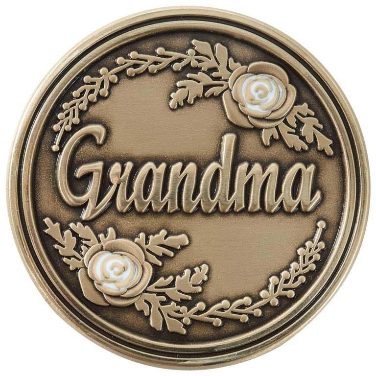 A bronze coin with the word grandma on it