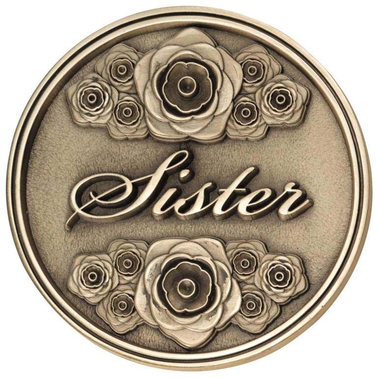 A coin with roses and the word sister on it