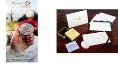 A person is holding a coin in their hand next to a table with cards and envelopes.