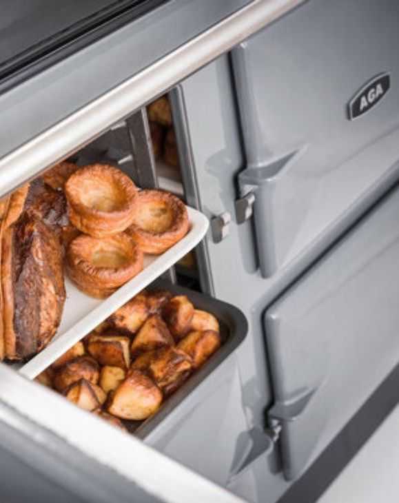 Food being removed from an AGA oven.