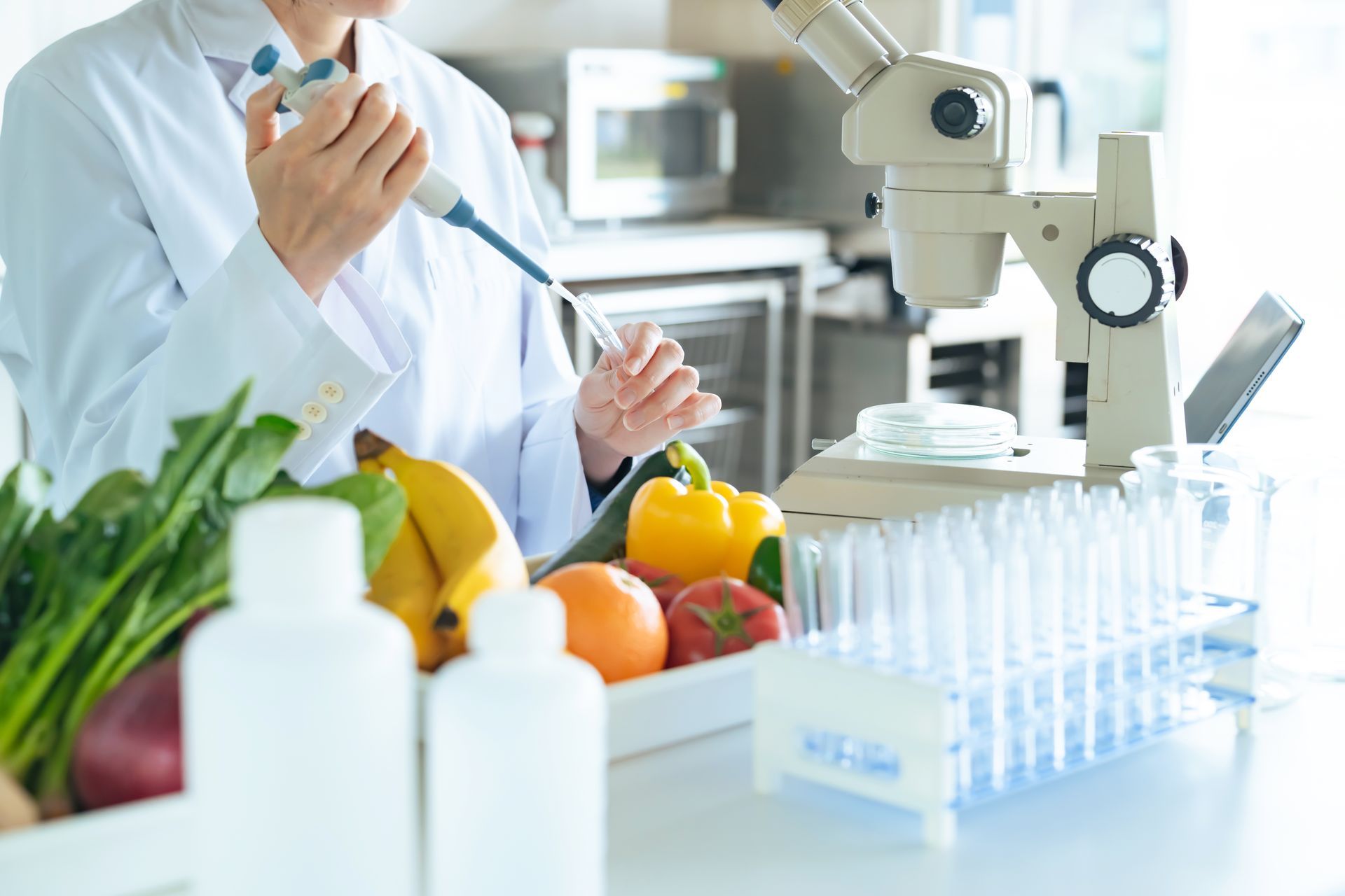 A scientist is using a pipette to test vegetables in a laboratory.
