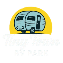 Logo for Tiny Town RV Park: blue camper against yellow sun, text 