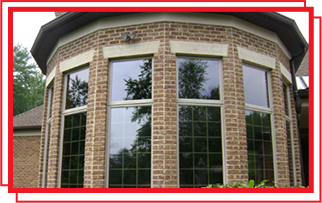 A curved brick building with a lot of windows