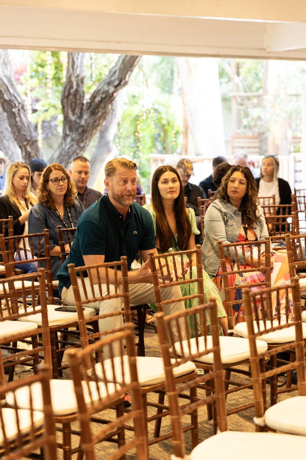 A group of people are sitting in chairs in a room.