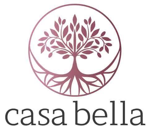 The logo for casa bella is a tree with roots in a circle.