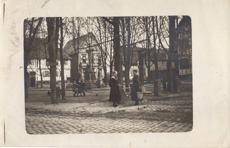 A black and white photo of people walking in a park