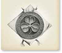 Black-and-white circular emblem with a four-petal clover-like design on a diamond-shaped background