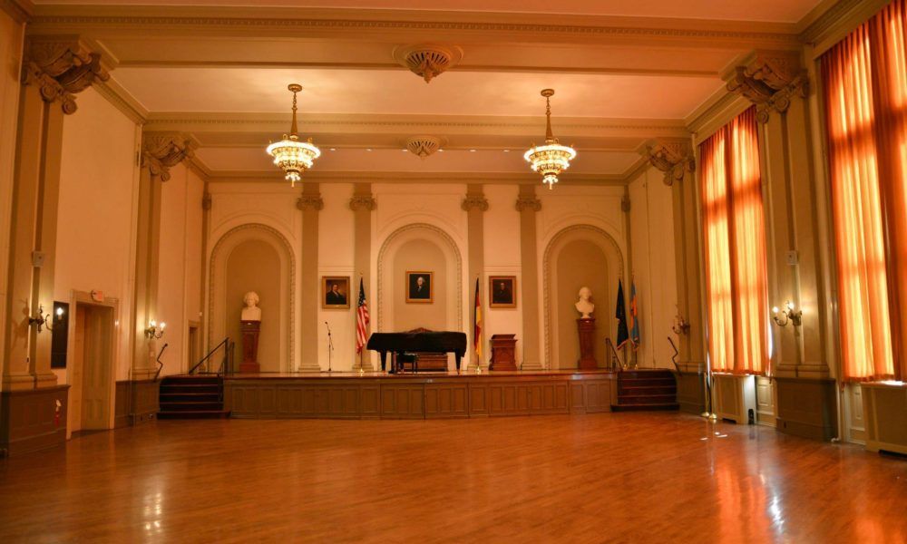 There is a piano in the middle of the room.