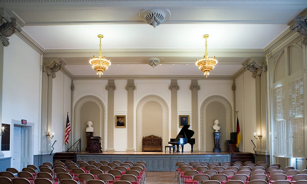 A large auditorium with a piano on the stage