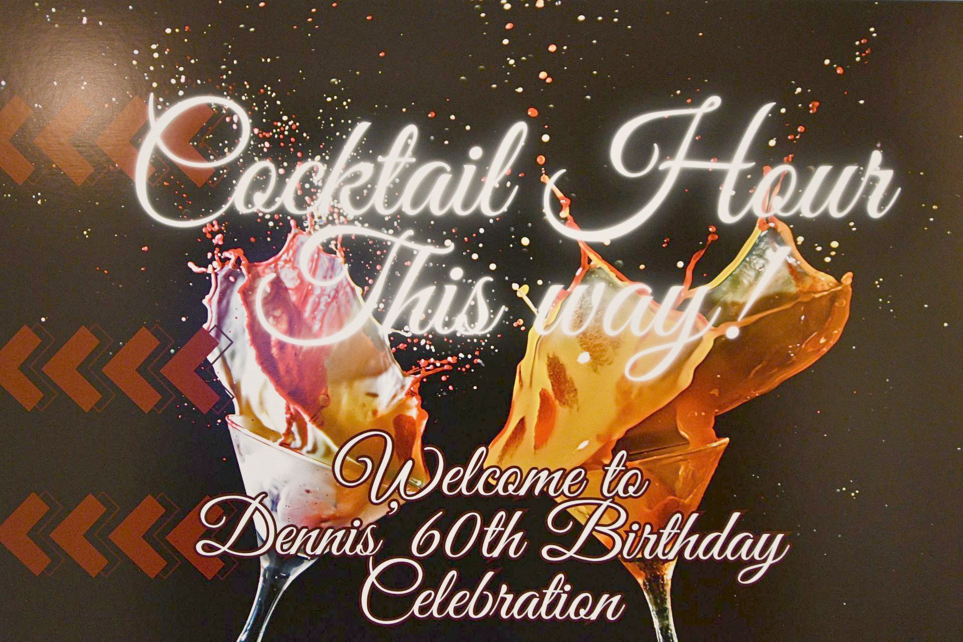 Cocktail Hour sign for Dennis’s 60th birthday, with splashing drinks in glasses against a dark background with decorative arrows.