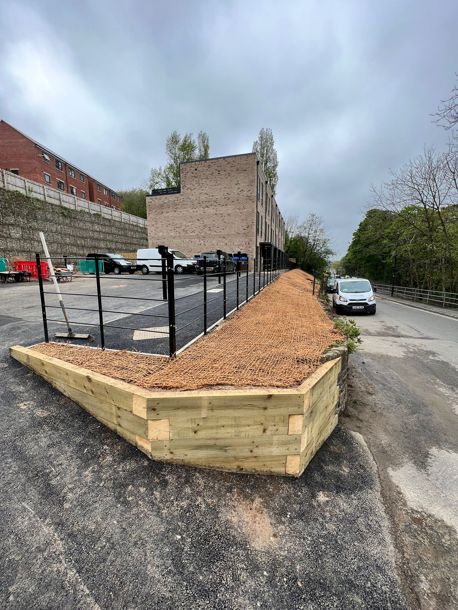 Raised sleeper beds, solil stabilization matting and then planted with plants