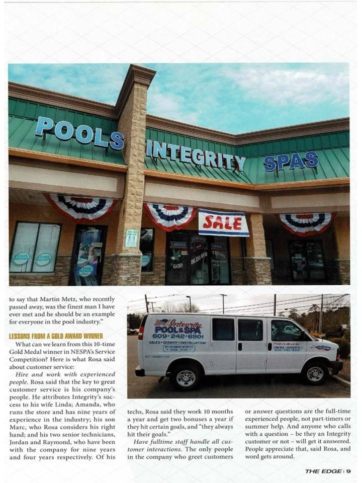 A white van is parked in front of a pools integrity store.