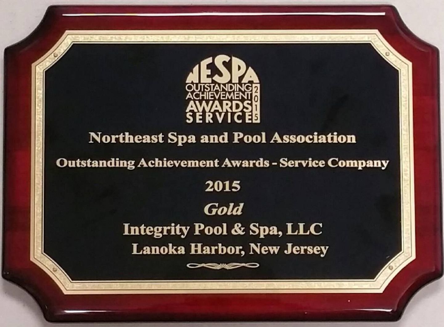 A plaque that says integrity pool & spa llc on it