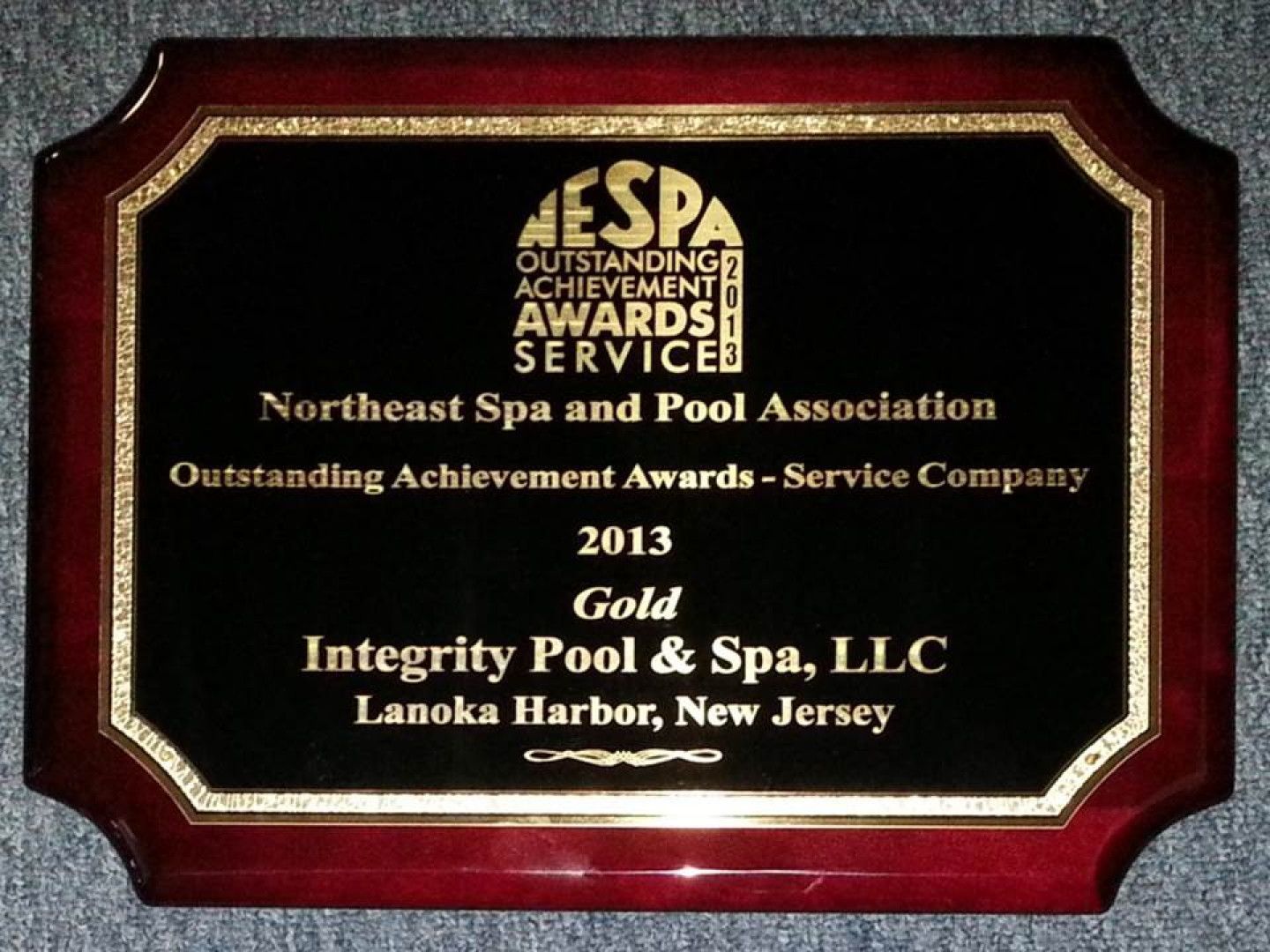A plaque that says integrity pool & spa llc on it