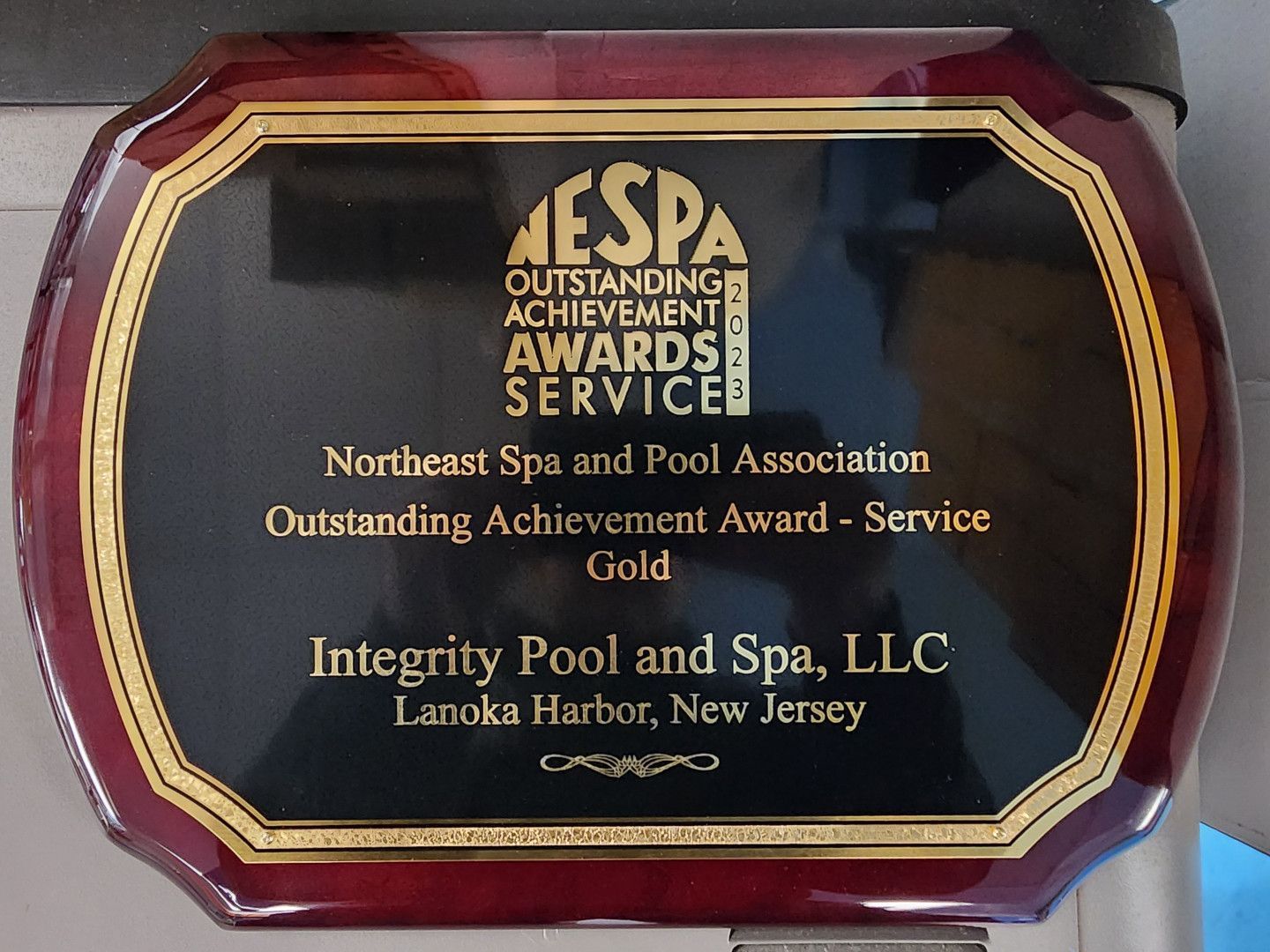 A plaque that says integrity pool and spa llc on it