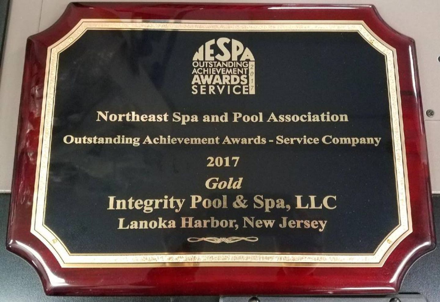 A plaque that says integrity pool & spa llc on it