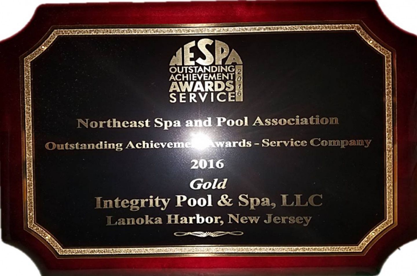 A plaque that says integrity pool & spa llc on it