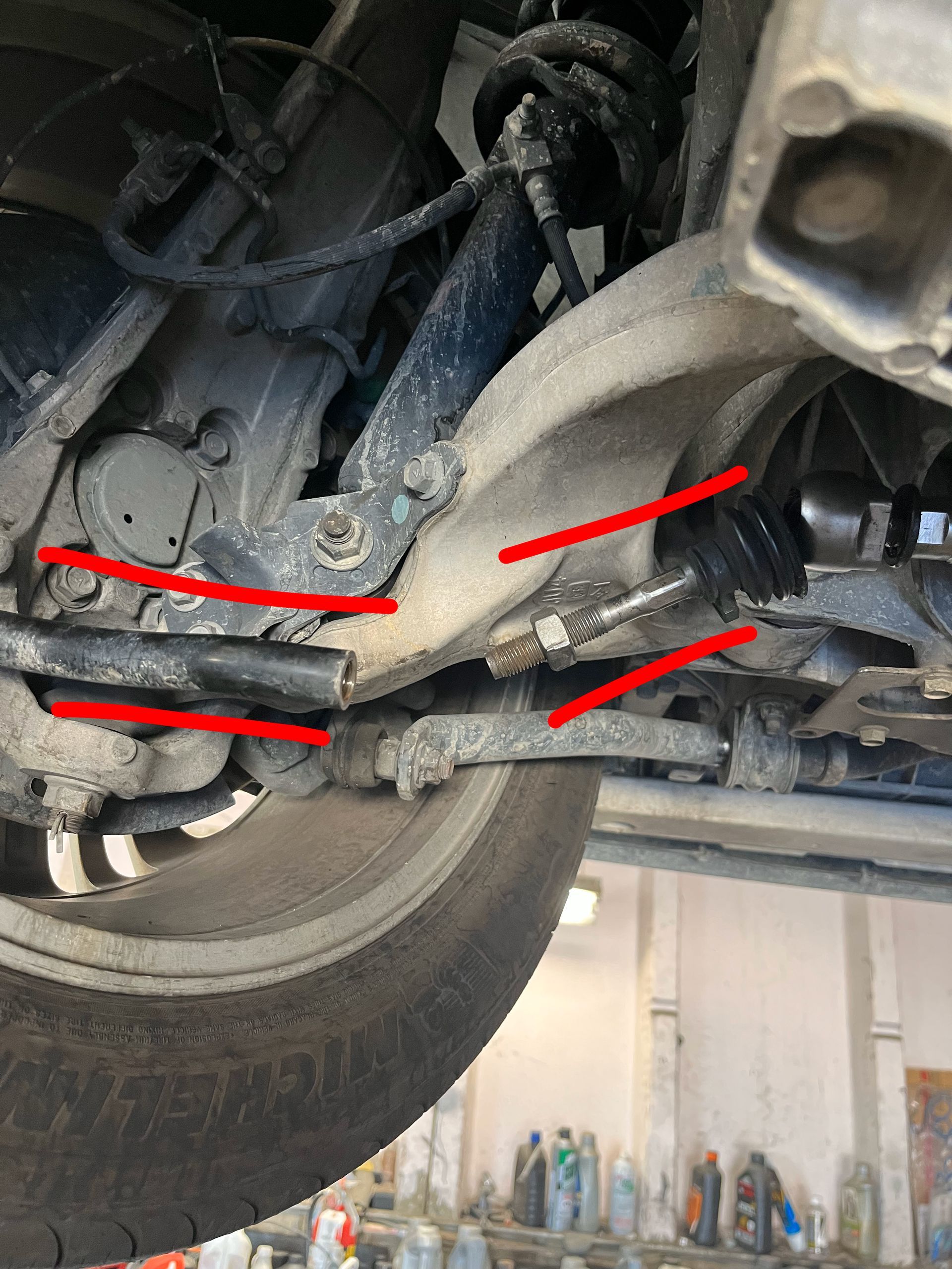 Car suspension components, side view, highlighting lower arms and steering components. | Jim Brangham Auto Repair