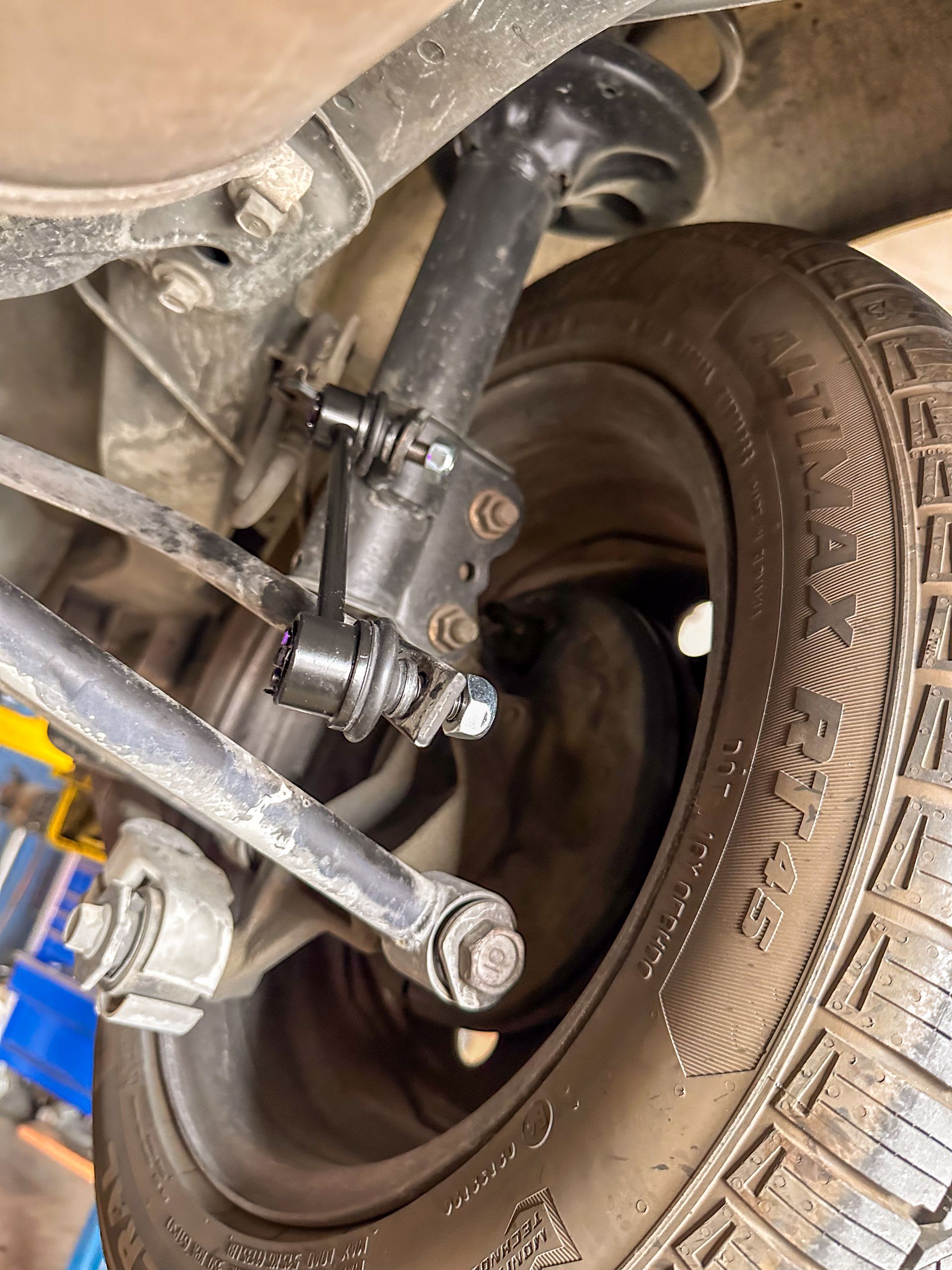 Black car suspension components near a tire. | Jim Brangham Auto Repair