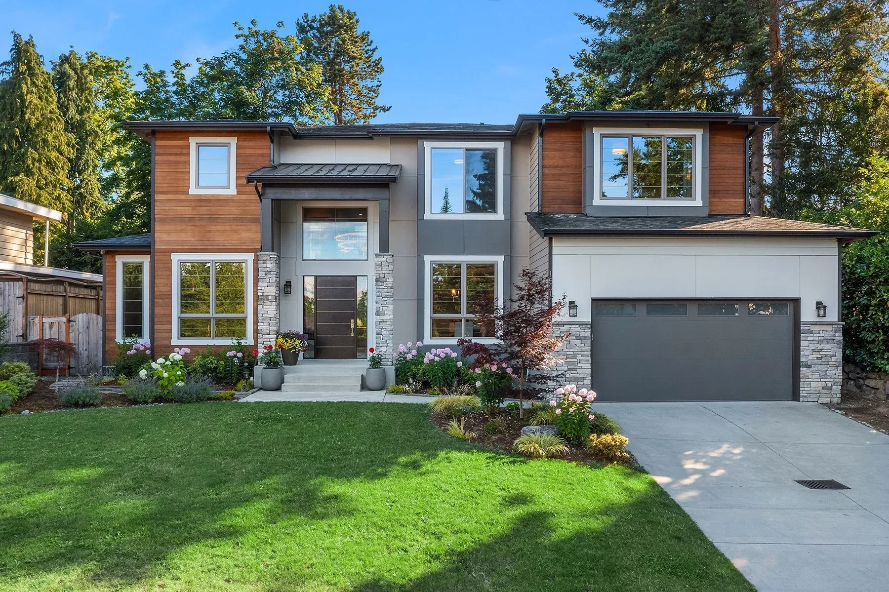 A large house with a lot of windows is sitting on top of a hill.