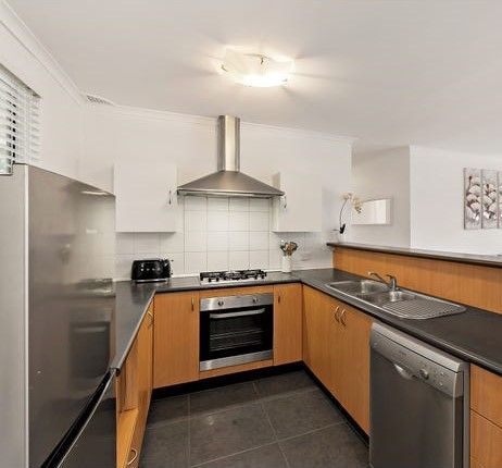 Modern kitchen with stainless steel appliances, light wood cabinets, and gray countertops — Wards Kitchens in Berkeley Vale, NSW