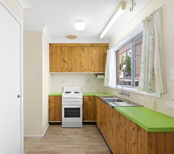 Small kitchen with wooden cabinets, lime green countertops, white appliances, and a window — Wards Kitchens in Berkeley Vale, NSW