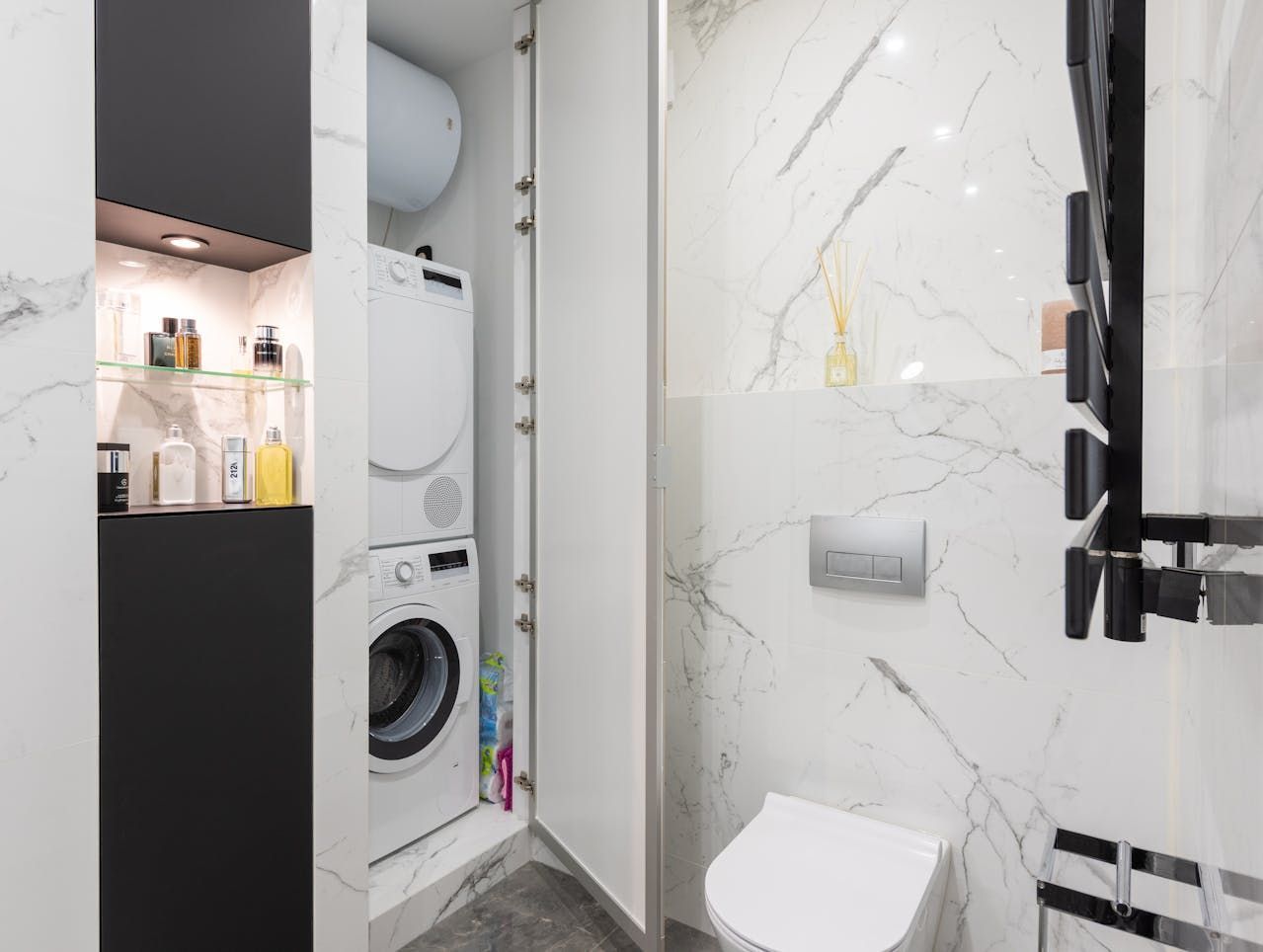 A Washing Machine Is Sitting In A Laundry Room Next To A Basket Of Clothes — Wards Kitchens in Berkeley Vale, NSW
